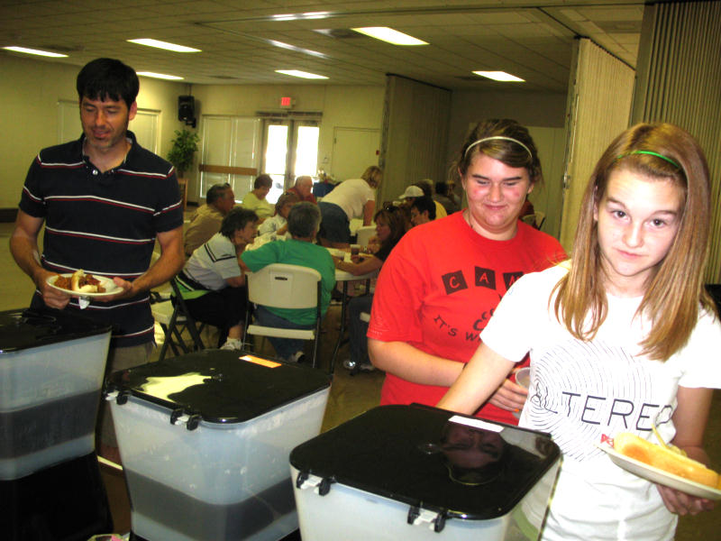 Youth Minister Billy Fly at left and two volunteers chow down at VBS.